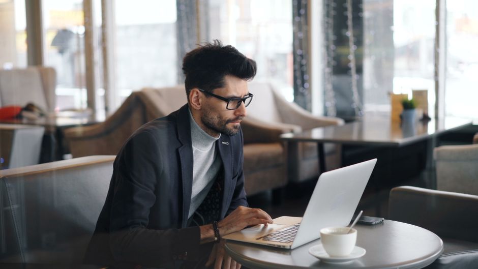 person thoughtfully using laptop